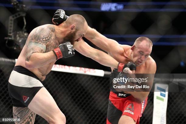 Travis Browne punches Aleksei Oleinik in their heavyweight bout during the UFC 213 event at T-Mobile Arena on July 9, 2017 in Las Vegas, Nevada.