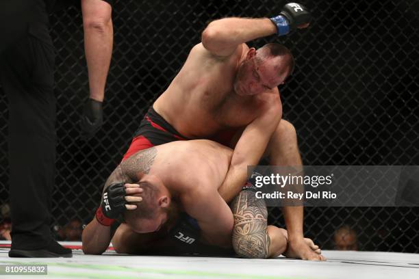 Aleksei Oleinik punches Travis Browne in their heavyweight bout during the UFC 213 event at T-Mobile Arena on July 9, 2017 in Las Vegas, Nevada.