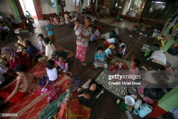 Families are given shelter at a buddhist monastery inhabited by internally displaced people on May 15 in a village on the outskirts of Yangon,...