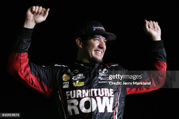 Martin Truex Jr., driver of the Furniture Row/Denver Mattress Toyota, celebrates in Victory Lane after winning the Monster Energy NASCAR Cup Series...