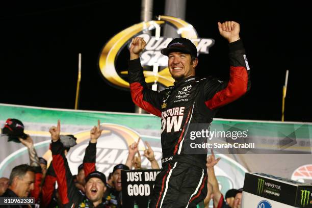 Martin Truex Jr., driver of the Furniture Row/Denver Mattress Toyota, celebrates in Victory Lane after winning the Monster Energy NASCAR Cup Series...