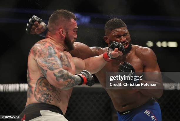 Daniel Omielanczuk of Poland punches Curtis Blaydes in their heavyweight bout during the UFC 213 event at T-Mobile Arena on July 8, 2017 in Las...