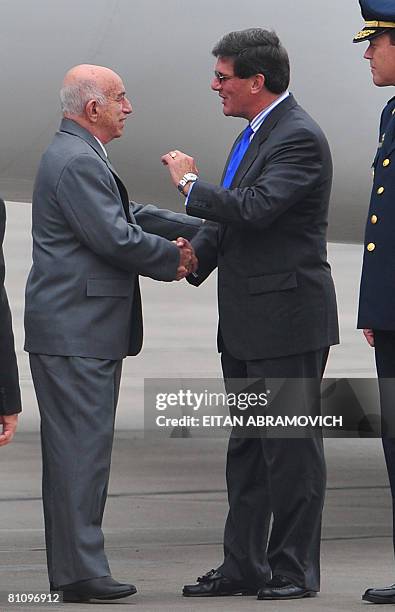 Cuban First Vice President Jose Ramon Machado Ventura is greeted by Peruvian Minister of Production Rafael Rey upon his arrival at the Peruvian Air...