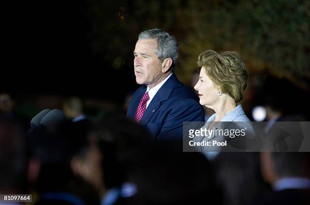 President George W. Bush speaks as First Lady Laura Bush looks on at a reception at the Israel Museum May 15, 2008 in Jerusalem, Israel. Bush earlier...