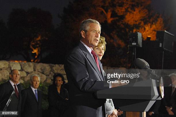President George W. Bush speaks as First Lady Laura Bush looks on at a reception at the Israel Museum May 15, 2008 in Jerusalem, Israel. Bush earlier...
