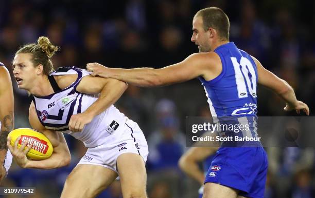 Nat Fyfe of the Dockers is tackled by Ben Cunnington of the Kangaroos during the round 16 AFL match between the North Melbourne Kangaroos and the...