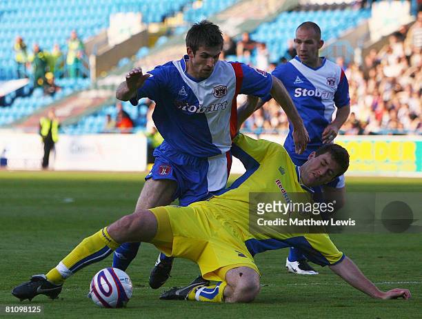 Scott Dobie of Carlisle is tackled by Lubomir Michalik of Leeds during the Coca-Cola League One Playoff Semi Final match between Carlisle United and...