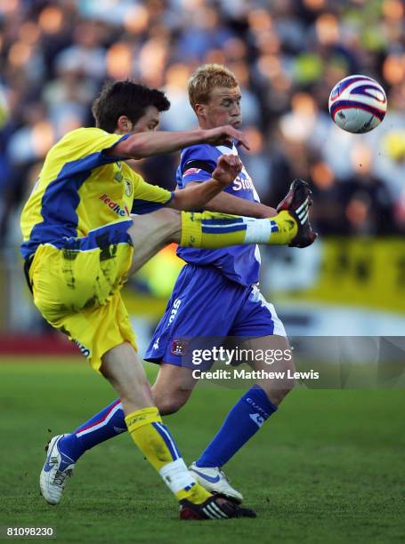 Chris Lumsdon of Carlisle and Jonathan Howson of Leeds challenge for the ball during the Coca-Cola League One Playoff Semi Final match between...