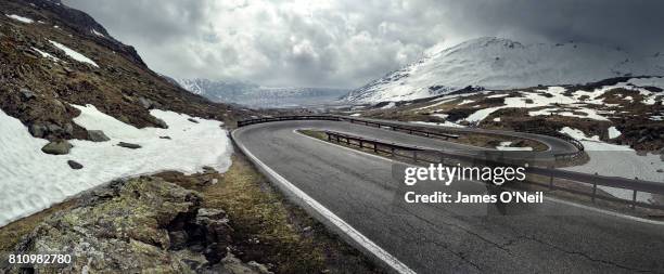 mountain road on stormy day - crash barrier stock pictures, royalty-free photos & images