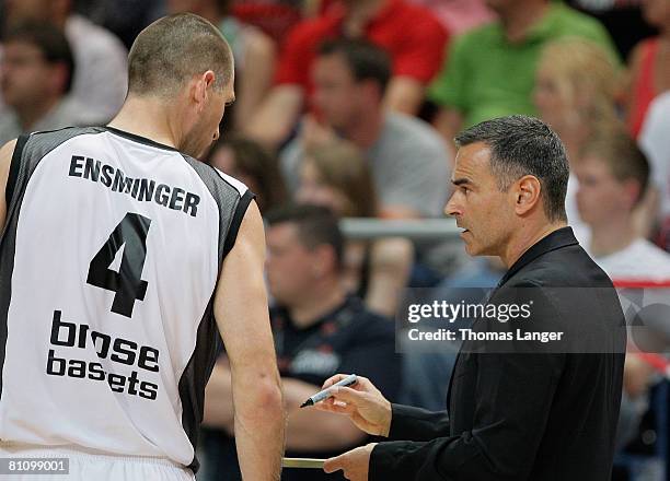 Head coach Dirk Bauermann of Bamberg speaks to Chris Ensminger during the Basketball Bundesliga quarter final play-off match between Brose Baskets...