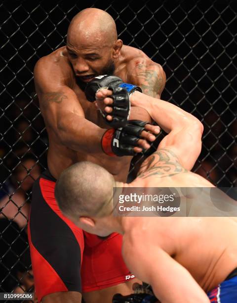 Robert Whittaker of New Zealand punches Yoel Romero of Cuba in their interim UFC middleweight championship bout during the UFC 213 event at T-Mobile...
