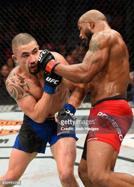 Yoel Romero of Cuba punches Robert Whittaker of New Zealand in their interim UFC middleweight championship bout during the UFC 213 event at T-Mobile...