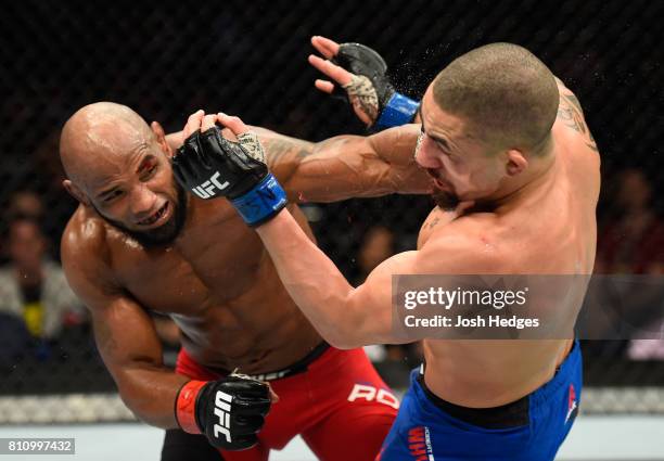 Yoel Romero of Cuba punches Robert Whittaker of New Zealand in their interim UFC middleweight championship bout during the UFC 213 event at T-Mobile...