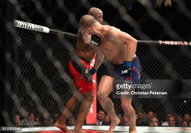 Yoel Romero of Cuba punches Robert Whittaker of New Zealand in their interim UFC middleweight championship bout during the UFC 213 event at T-Mobile...
