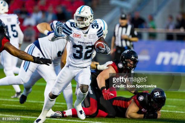 Toronto Argonauts running back James Wilder prepares to stiff arm a defender during Canadian Football League action between the Toronto Argonauts and...