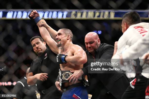 Robert Whittaker celebrates after his victory over Yoel Romero in their interim UFC middleweight championship bout during the UFC 213 event at...