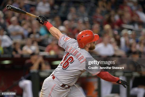 Tucker Barnhart of the Cincinnati Reds hits a solo home run during the ninth inning of the MLB game against the Arizona Diamondbacks at Chase Field...