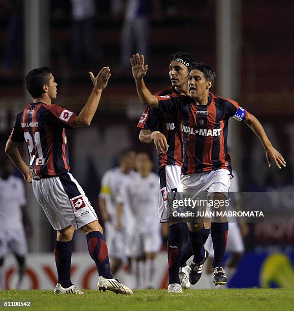 Defender Hernan Gonzalez , of Argentina's San Lorenzo, celebrates with teammates Cristian Tula and Nestor Silvera after scoring against Ecuador's...