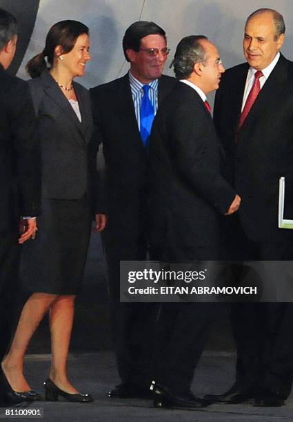 Mexican President Felipe Calderon and his wife Margarita Zavala listen to Peruvian Minister of Production Rafael Rey and an unidentified Peruvian top...