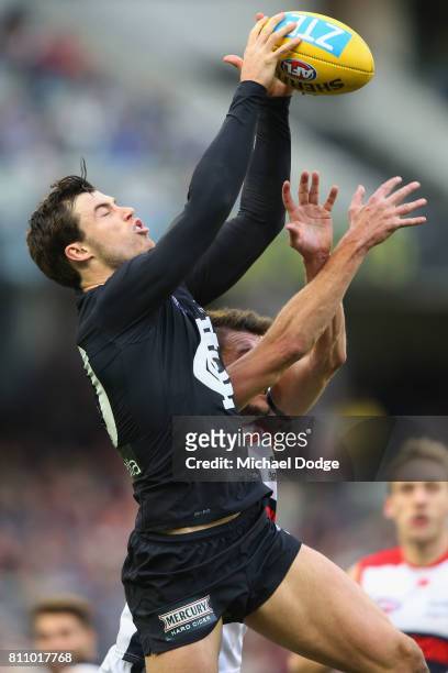 Lachie Plowman of the Blues marks the ball during the round 16 AFL match between the Carlton Blues and the Melbourne Demons at Melbourne Cricket...