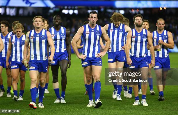 Jack Ziebell of the Kangaroos, Majak Daw of the Kangaroos, Todd Goldstein of the Kangaroos leave the field with their teammates after losing the...