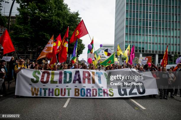 Demonstrators carry the front transparent, in Hamburg, Germany, on July 8, 2017. Under the motto &quot;Solidarity without borders instead of...