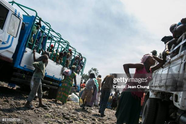 Displaced people in Mugunga I say the final farewells before the truck takes them back to their home villages on June 24, 2014 in Goma, Democratic...