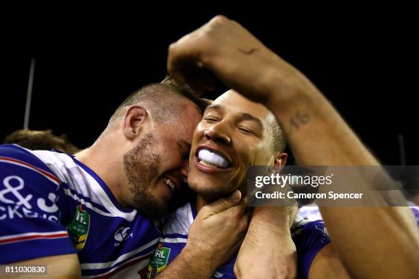 Josh Reynolds of the Bulldogs embraces team mate Moses Mbye of the Bulldogs after scoring the winning try during the round 18 NRL match between the...