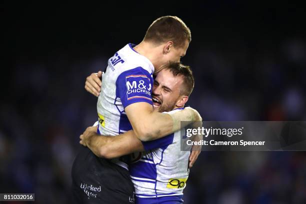 Josh Reynolds of the Bulldogs celebrates with team mate Kerrod Holland during the round 18 NRL match between the Canterbury Bulldogs and the...