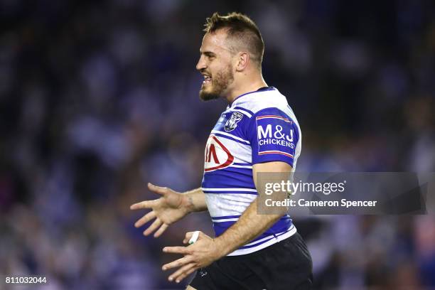 Josh Reynolds of the Bulldogs celebrates a conversion by team mate Kerrod Holland during the round 18 NRL match between the Canterbury Bulldogs and...