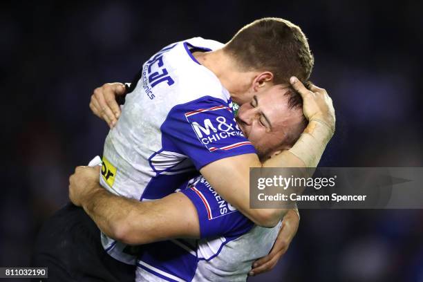 Josh Reynolds of the Bulldogs celebrates a conversion kicked by team mate Kerrod Holland during the round 18 NRL match between the Canterbury...