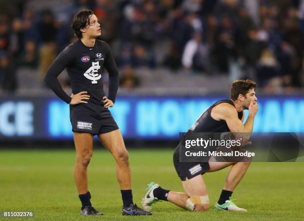 Jack Silvagni of the Blues and Levi Casboult look dejected after defeat during the round 16 AFL match between the Carlton Blues and the Melbourne...