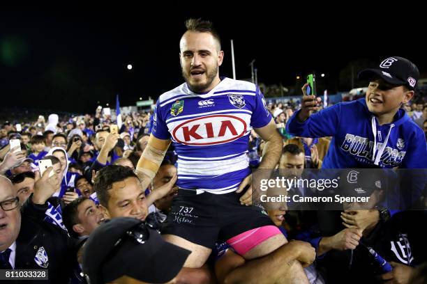 Josh Reynolds of the Bulldogs is chaird off the field after winning the round 18 NRL match between the Canterbury Bulldogs and the Newcastle Knights...