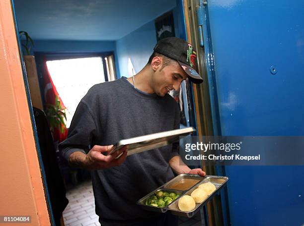 Prisoner Atif picks up his lunch in front of his prison cell at the Iserlohn prison on May 15, 2008 in Iserlohn, Germany. The prison in North...