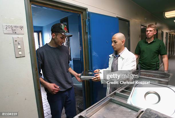Prisoner Atif picks up his lunch at the Iserlohn prison on May 15, 2008 in Iserlohn, Germany. The prison in North Rhine-Westphalia inhabits 292...