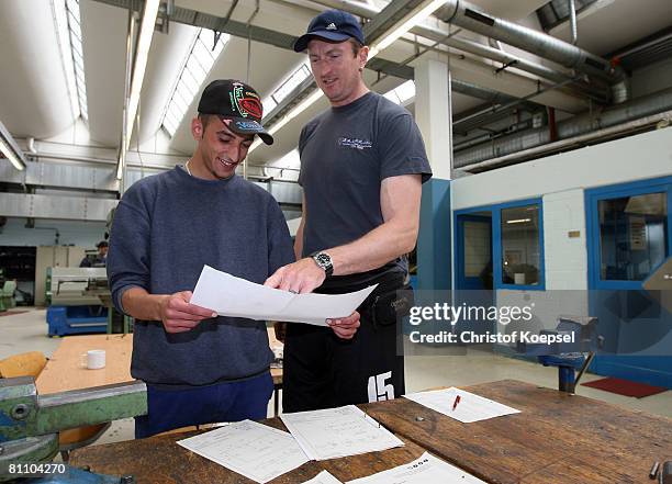 Prisoner Atif and justice officer Ingo Siebert watch a script of metal tools at the Iserlohn prison on May 15, 2008 in Iserlohn, Germany. The prison...