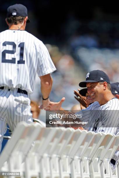 Former player Tino Martinez shakes hands with Paul O'Neill of the New York Yankees during introductions for the New York Yankees 71st Old Timers Day...