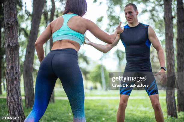 wrestling a guy and a girl - girl wrestling stock pictures, royalty-free photos & images