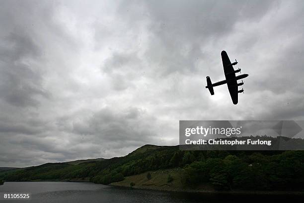 Lancaster bomber flies over Ladybower reservoir in the Derbyshire Peak District to mark the 65th anniversary of the World War II Dambusters mission...