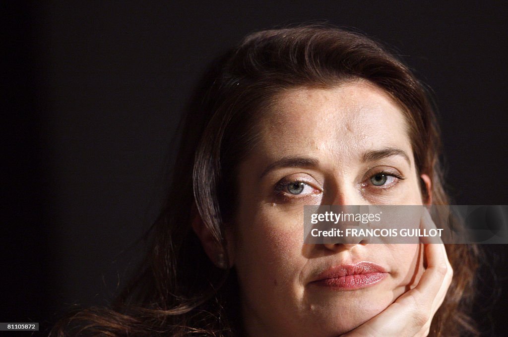 French actress Emmanelle Devos listens t