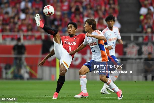 Rafael Silva of Urawa Red Diamonds and Masaru Kato of Albirex Niigata compete for the ball during the J.League J1 match between Urawa Red Diamonds...