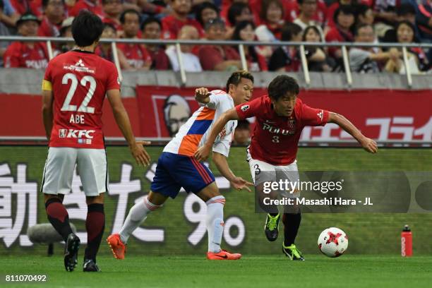 Tomoya Ugajin of Urawa Red Diamonds and Kei Koizumi of Albirex Niigata compete for the ball during the J.League J1 match between Urawa Red Diamonds...