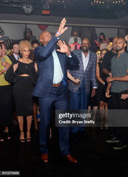 Former professional basketball player and coach Byron Scott dances in a "Soul Train line" during the Coach Woodson Las Vegas Invitational red carpet...