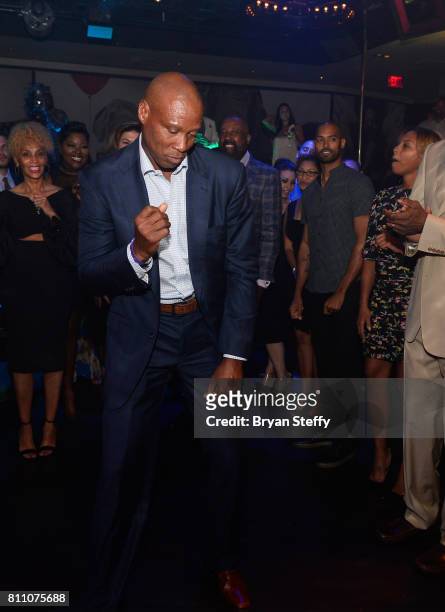 Former professional basketball player and coach Byron Scott dances in a "Soul Train line" during the Coach Woodson Las Vegas Invitational red carpet...