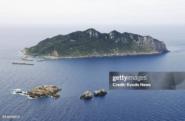 Undated file photo shows the island of Okinoshima and nearby reefs in Fukuoka Prefecture. The World Heritage Committee of the United Nations...