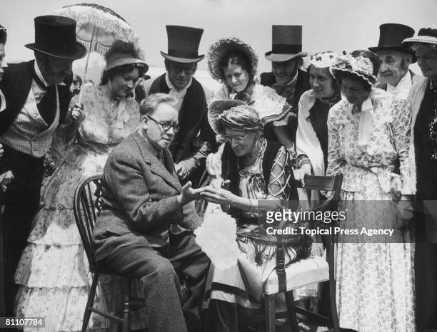 British statesman Herbert Morrison has his palm read by Mrs Vaughan Williams at the Brockham Green Festival in Surrey, 2nd July 1951.