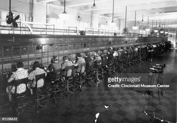 View of half of the operators at work on world's longest straight switchboard at the City and Suburban Telegraph Company , Cincinnati, Ohio, 1930s.
