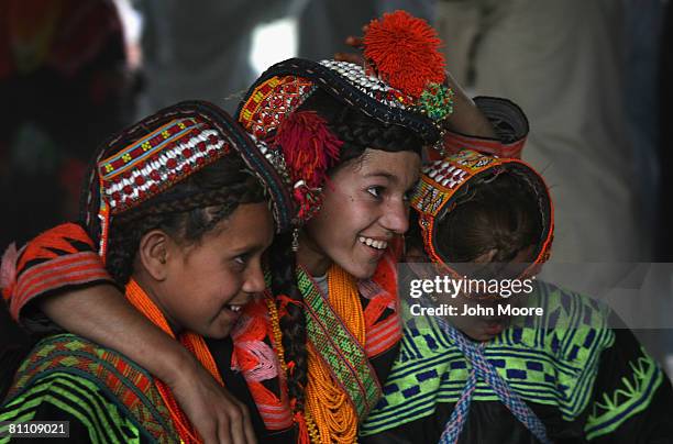 Girls from the polytheistic Kalash tribe embrace while dancing at the Joshi spring festival May 15, 2008 in the remote Chitral village of Rumbur in...