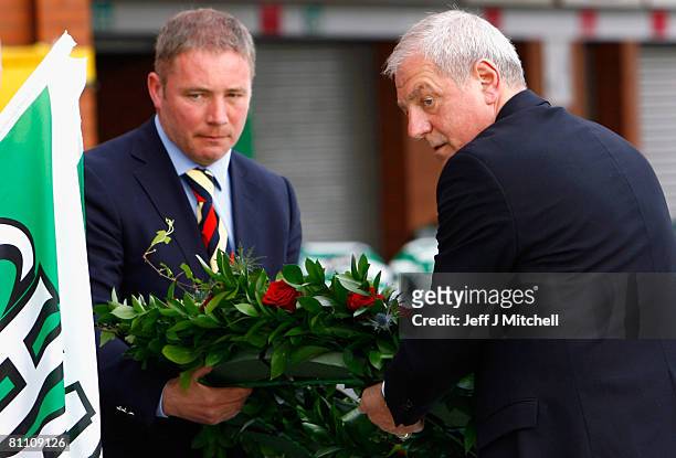 Walter Smith and Ally McCoist of Rangers, carry a wreath as they pay tribute at Celtic Park, to Celtic and Scotland legend, Tommy Burns who died...