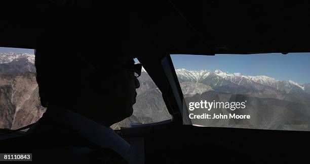 Pilot flies over the Hindu Kush mountains and the rugged terrain of Chitral, home of the Joshi spring festival May 15, 2008 in northwestern Pakistan....